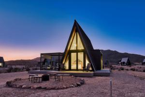 a small house with a triangular roof in the desert at Stardust Big Bend Luxury A-Frame#1 with a fab view in Terlingua