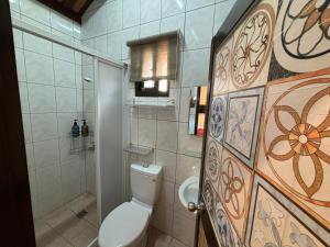 a bathroom with a toilet and a shower at 八八古藝民宿可包棟 in Jinning +152 photos