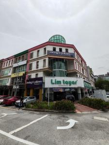 a building with a sign on the front of it at Pillows Plus Kota Damansara in Kota Damansara
