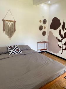 a bedroom with a bed and a side table at Moalboal Panagsama beach TopBudz Hostel in Moalboal
