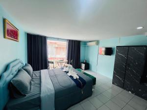 a bedroom with a bed with a stuffed animal on it at Ocean Blue Huahin Guesthouse in Hua Hin