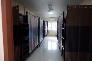 a row of lockers in a room with a hallway at Khaosok city hostel in Khao Sok National Park