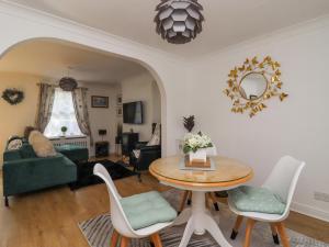 a living room with a table and chairs at Ted's Cottage in Skipton
