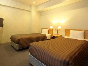 Tempat tidur dalam kamar di Nishiizu Crystal View Hotel