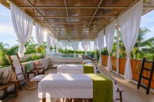 a hotel room with two beds and a balcony at Agua de Luna Hotel Boutique, San Pancho Nayarit in San Francisco