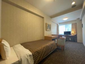 Tempat tidur dalam kamar di Nishiizu Crystal View Hotel