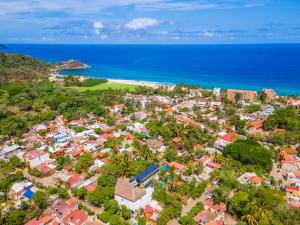 an aerial view of a town next to the ocean at Agua de Luna Hotel Boutique, San Pancho Nayarit in San Francisco