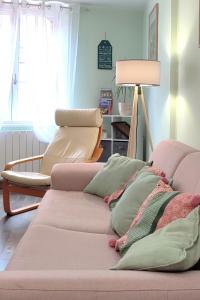 a living room with a couch and a lamp at Blois City - Le Petit Louis XII in Blois