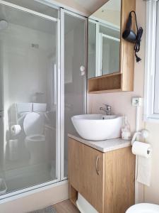a bathroom with a sink and a glass shower at Sunset Spot à Bredene in Bredene +33 photos