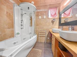 a bathroom with a tub and two sinks and a shower at Maison Style Chalet 4 étoiles avec Jacuzzi- La Sérénité de Sailhan in Camparan +34 photos