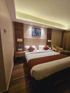 a bedroom with a large bed in a hotel room at Utham Mahal in Anchal +40 photos