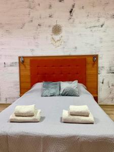 a bed with two towels on top of it at Апартамент Горски кът in Lukovit