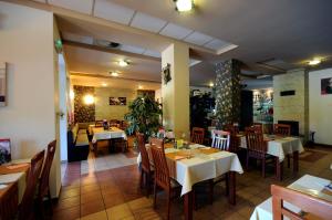 a dining room with tables and chairs in a restaurant at Penzión Zivka in Závažná Poruba