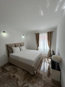 a bedroom with a large bed in a room at House Pravilovic apartments in Cetinje