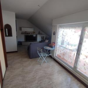 a living room with a couch and a window at Atico en Ajo Cantabria in Ajo