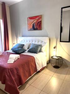 a bedroom with a large bed with a red blanket at ROMA ARCHAEOLOGICAL PARK Apartment in Ostia Antica