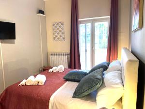 a bedroom with a bed with towels on it at ROMA ARCHAEOLOGICAL PARK Apartment in Ostia Antica