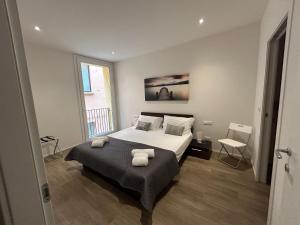 a bedroom with a bed with two towels on it at Ariosti 3 - Piazza Maggiore in Bologna