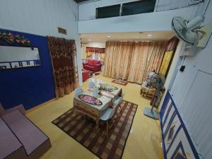 an overhead view of a living room with a table at Iltizam Homestay in Kuala Berang