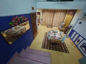 an overhead view of a living room with a table and chairs at Iltizam Homestay in Kuala Berang
