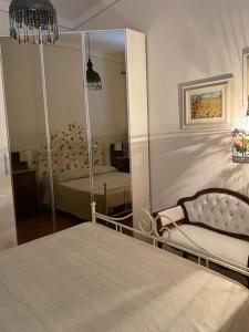 a bedroom with a mirror and a bed and a chair at Casa d'artista in Empoli