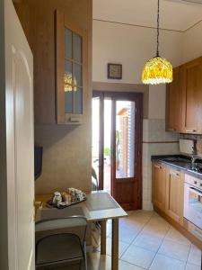 a kitchen with a table and a dining room at Casa d'artista in Empoli