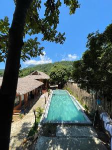 a view of a swimming pool at a resort at Mai Chau Tropical Homestay in Hòa Bình