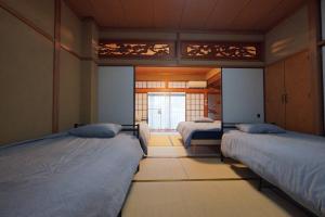a room with two beds and a window at The house of calmness in Beppu +95 photos