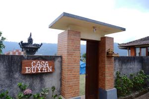 a brick building with a sign that reads casa buruana at Casa Buyan in Singaraja