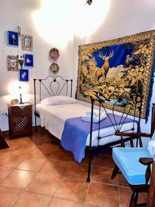 a bedroom with a bed with a painting of a deer at Alexjean cosy apartment close to beach and Dapia in Spetses +97 photos