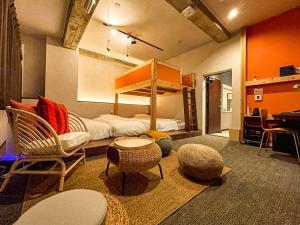a room with a bed and a couch and chairs at Many Thanks Resort Onomichi - Vacation STAY 15792 in Onomichi