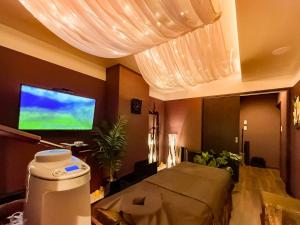 a bedroom with a bed and a flat screen tv at Many Thanks Resort Onomichi - Vacation STAY 15793 in Onomichi