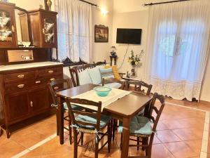 a living room with a wooden table and chairs at Alexjean cosy apartment close to beach and Dapia in Spetses