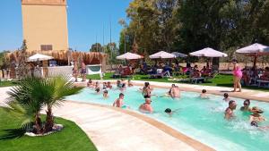 a group of people in a swimming pool at Oasi Le Fontanelle in Cerignola
