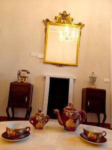 a table with two tea pots and cups on it at CAVOUR257 in La Spezia