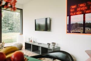 a living room with a tv on a wall at Ferienwohnung Cleo in Mirow