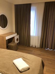 a hotel room with a bed and a window at Svani in Borjomi +1 photo