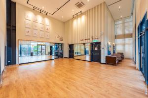 an empty lobby with a wooden floor and windows at Mossaz Premier Suites Damansara in Kampong Bukit Lanjan