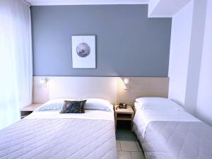 Postel nebo postele na pokoji v ubytování Aura Living Hotel