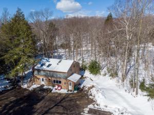 an aerial view of a house in the snow at DancingBears- 8BR, 2 Hot Tubs, 2 Homes, Game Room, AC! in Killington