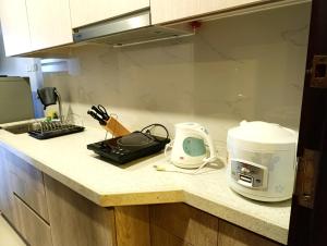 a kitchen counter with a microwave and a toaster at Baguio Transient 6F-9 Megatower Residences II in Baguio