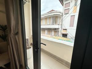 a door to a balcony with a view of a building at 25Studio House - District 1 in Ho Chi Minh City