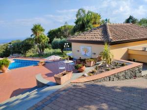 a house with a patio and a swimming pool at Casa dell'Antico Ulivo 2 by Holiday World in Nunziata