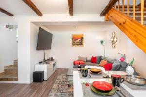 a living room with a couch and a tv at Ferienhaus-am-Osterberg in Allrode