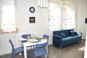 a living room with a table and a blue couch at La Dimora In Blu in Bologna