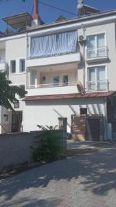 a white building with a fence in front of it at WoodenGate in Fethiye
