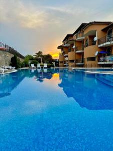 a large swimming pool in front of a hotel at Cozopol Budjaka in Sozopol