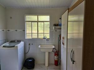 a small bathroom with a sink and a toilet at Sossego e Fé in Ouro Fino +18 photos