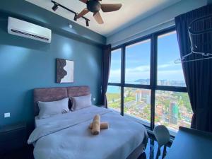 a teddy bear sitting on a bed in a blue bedroom at Jovial Modern&Stylish `UrbanSuites in Jelutong +74 photos