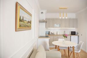 a living room and kitchen with a table and chairs at Mieszkanie Central Park in Ciechanów
